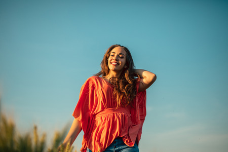 Portrait of a smiling young woman enjoying in the nature.の写真素材