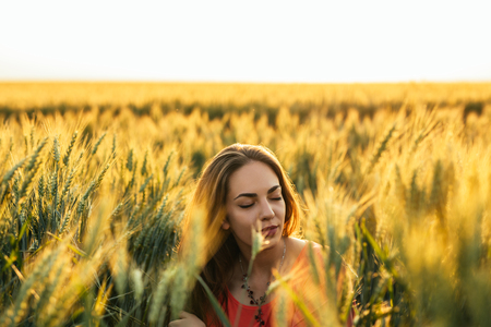 Portrait of a young woman enjoying in the fields.の写真素材
