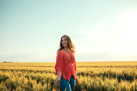Portrait of a beautiful woman walking in the fields.の写真素材