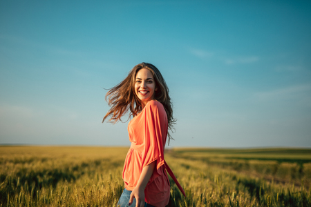 Portrait of a beautiful woman walking in the fields.の写真素材