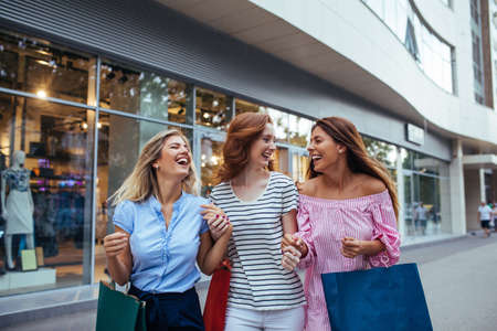 Photo of friends enjoying shopping together outdoors.の写真素材