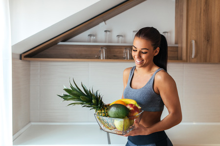 Attractive beautiful woman bringing fruit for breakfast.の写真素材
