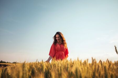 Portrait of a smiling young woman enjoying in the countryside.の写真素材