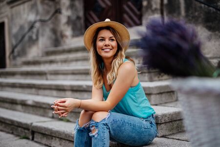 Beautiful woman relaxing outdoors in the city.の写真素材