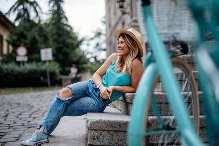Beautiful woman relaxing outdoors in the city.の写真素材