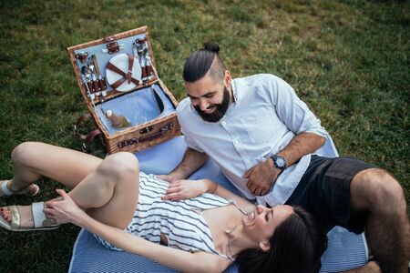 Young couple enjoying on a picnic outdoors.の写真素材
