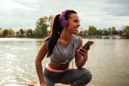 Photo of an athlete woman listening to the music.の写真素材