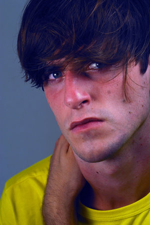 Portrait of a young man in a thoughtful pose.の写真素材