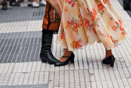 A couple of folkloric dancers dressed in traditional style dancing in the streets of Buenos Aires.の写真素材