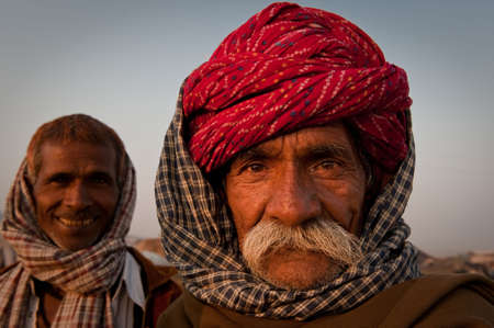 Headshot of two rajasthani men looking at the camera with a friendly expression at the Pushkar Camel Fair 2009のeditorial素材