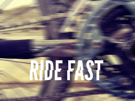 Photograph of a bicycle stars, gears and chain, with the words: RIDE FAST in white capital letters
