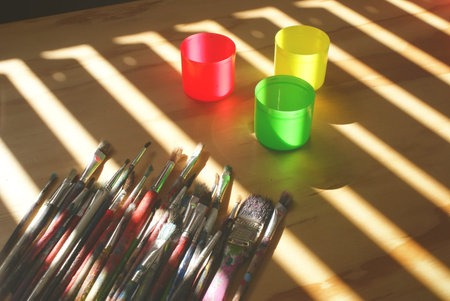 Photograph of some art brushes on a wood table