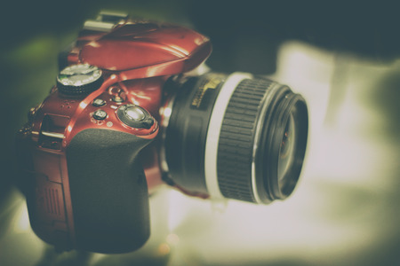 Photograph of a red reflex camera on a blurred backgroundの写真素材
