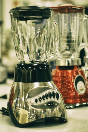 Photograph of some electric metal blenders on a store counterの写真素材