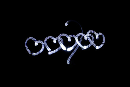 Photograph of some hearts drawing made with long exposure light effect