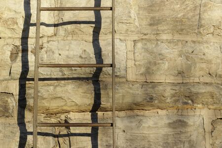 Photograph of a metal stair on stone wallの写真素材