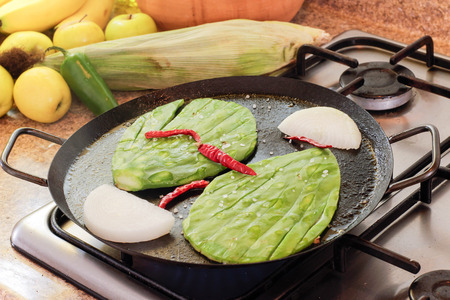 Photograph of some nopals on a hot pan on a stoveの写真素材