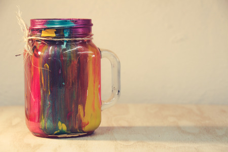 Photograph of a colorful cristal bottle with dripped paint insideの写真素材