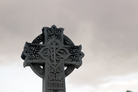 Stone religious sculpted Cross with symbolsの写真素材