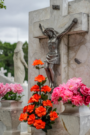 Photograph of a stone and metal crucifix statueの写真素材