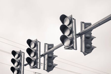 Photograph of some traffic lights and cloudy skyの写真素材