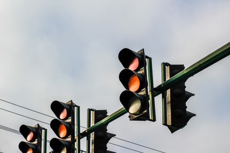 Photograph of some Traffic lights and cloudy sky