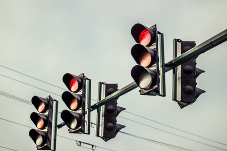 Photograph of some traffic lights and cloudy sky