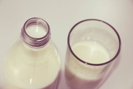 Photograph of a Bottle and glass of milk on white backgroundの写真素材