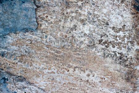 Photograph of a stone cracked wall texture or backgroundの写真素材