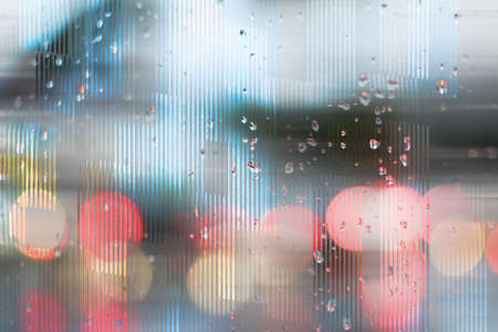 Photograph and digital manipulation of a traffic scene through a wet glass and with bokeh effectの写真素材