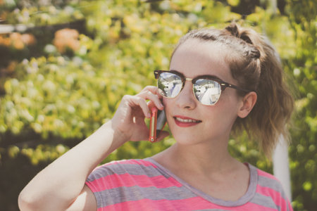 Photograph of a young modern woman using her cellphone