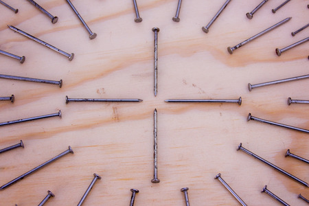 Photograph of some Metal nails in geometric composition and cross symbolの写真素材
