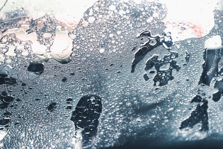 Photograph of a wet car window in car wash