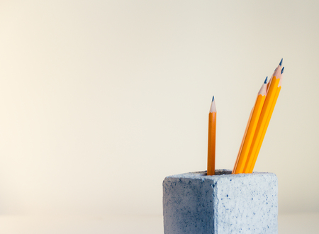 Photograph of some Yellow wood pencils and concrete cubeの写真素材