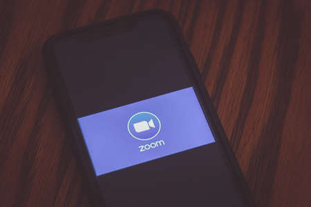 MONTERREY, NUEVO LEON / MEXICO -  09 06 2020: Photograph of  Zoom app logo displayed on cellphone on wood tableのeditorial素材