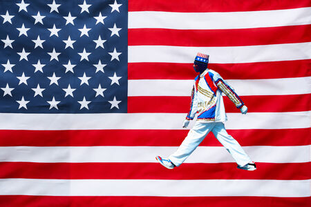 This picture shows a patriot you wakling on the flag of the united Statesの写真素材