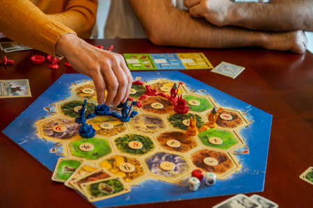 Balogunyom / Hungary - 01.04.2019: Board game party Settlers of Catan, popular board game. Players are scrambling the area to get more resources and victory points.のeditorial素材