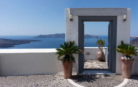 Typical design decoration door of Santorini Greece with way into the sea with copy spaceの写真素材