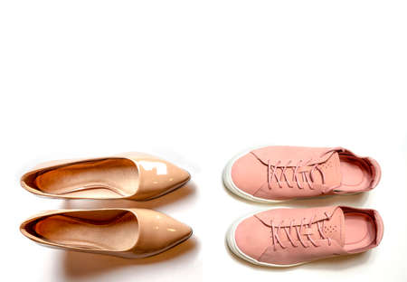 women's shoes choice what to wear conception elegant or sporty on white isolated backgroundの写真素材