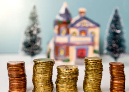 stack of coins with house property in the background Concept of Investment propertyの写真素材