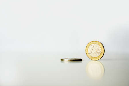 used One 1 and two 2 euro coins with reflection white backgroundの写真素材