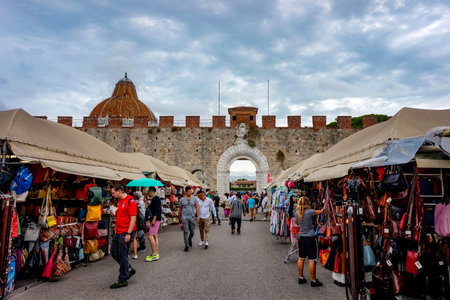 Pisa, Tuscany / Italy - 09.15.2017: Souvenirs for sale at stalls close to the Leaning Tower of Pisa before the square gateのeditorial素材