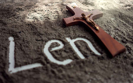 Lent word written in ash and christian cross as a T letter a religion concept Ash wednesday backgroundの写真素材
