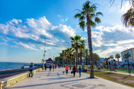 Spain, Malaga - 04.04.2019: Pathway along the malagueta beach at Malaga, Spain, Europe on a bright summer day palm treesのeditorial素材
