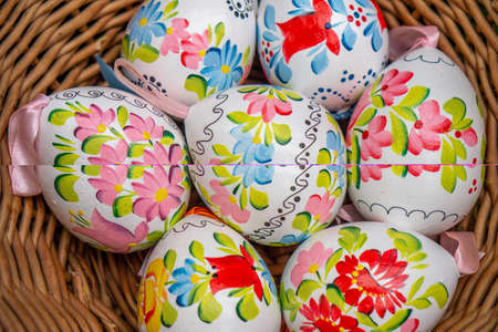 many Close up of colorful decorted hand painted Easter eggs in a basketの写真素材