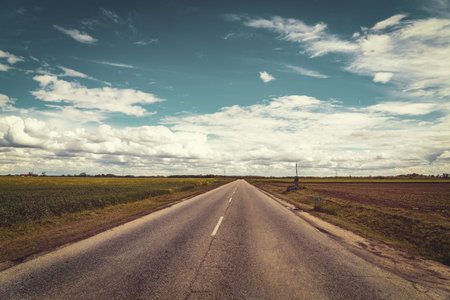 free road retro roadtrip freedom goal concept with cloudy skyの写真素材