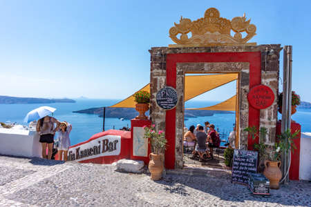 Santorini Island, Greece - 09.05.2018 : View of the Aegean Sea on the island of Santorini with the entrance to the famous PK cocktail bar Palia Kameni with peopleのeditorial素材