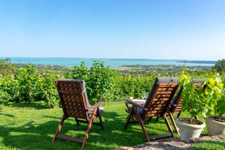 table and chairs over the Lake Balaton on the hill romantic date, picnic, eating on nature. Csopak wine tastingの写真素材