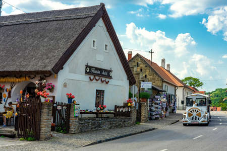 Tihany, Hungary - 06.10.2019 : Folkloric old houses souvenir shop in Tihany with the little city tourist train on the northern shore of Lake Balatonのeditorial素材
