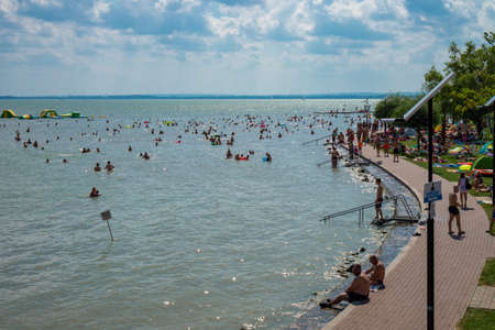 Vonyarcvashegy, BALATON, HUNGARY - July 27, 2019: people swimming in blue azure lake Balaton summertimeのeditorial素材
